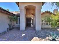 Inviting front entrance featuring brick walkway and attractive stone columns and tile roof at 309 E Mountain Sky Ave, Phoenix, AZ 85048