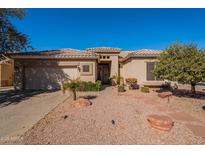 Charming single-story home featuring a desert landscape, tile roof, and a two-car garage at 4266 E Cassia Ln, Gilbert, AZ 85298