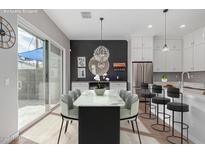 Bright dining area features a modern table, stylish chairs, and access to the outdoor patio at 6301 N 12Th St # 14, Phoenix, AZ 85014