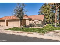 Charming home featuring a red-tiled roof, tan stucco exterior, and a well-maintained lawn at 945 N Pasadena -- # 52, Mesa, AZ 85201