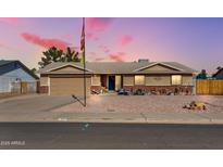 Charming single-story home with desert landscaping and inviting front porch seating at 1353 N Avoca --, Mesa, AZ 85207