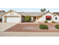 Charming single-story home featuring a two-car garage and low-maintenance desert landscaping at 13548 W Whitewood Dr, Sun City West, AZ 85375