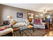 Inviting living room featuring comfortable seating, stylish rug, and warm, neutral tones at 13633 N 111Th Ave, Sun City, AZ 85351