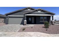 Charming single-story home with a two-car garage, desert landscaping, and a welcoming front porch at 15762 W Cheryl Dr, Waddell, AZ 85355