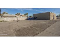 An expansive and well maintained parking area in front of a commercial building with a gray stucco finish at 1610 W Buckeye Rd, Phoenix, AZ 85007