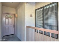 Inviting condo entrance featuring stylish front door, balcony, and unit number at 16631 E El Lago Blvd # 214, Fountain Hills, AZ 85268