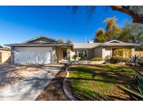 Charming single-story home featuring a well-manicured lawn, desert landscaping, and a two-car garage at 2201 S Evergreen Rd, Tempe, AZ 85282