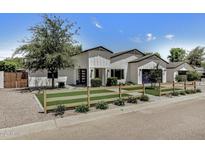 Charming single-Gathering home featuring a white exterior, modern design, and well-manicured front yard at 3007 N 47Th St, Phoenix, AZ 85018