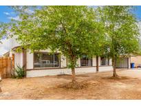 Charming single-story home featuring desert landscaping, brick accents, and mature trees at 3042 N 87Th Ave, Phoenix, AZ 85037