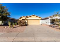 Inviting single-story home featuring a neutral-toned exterior, two car garage and low-maintenance desert landscaping at 306 W Angus Rd, San Tan Valley, AZ 85143