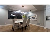 Elegant dining room with modern light fixture and neutral color palette, perfect for entertaining at 30600 N Pima Rd # 19, Scottsdale, AZ 85266