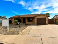 Charming single-story home with desert landscaping, inviting entryway, and attached garage at 1109 E Emerald Ave, Mesa, AZ 85204