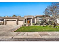 Charming single-story home with stone accents, a three-car garage, and manicured landscaping at 1738 W Yosemite Pl, Chandler, AZ 85248