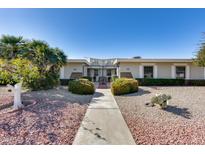 Charming single-story home with a well-maintained xeriscaped front yard and pathway to a gated entrance at 17428 N Boswell Blvd, Sun City, AZ 85373