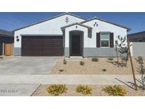 Charming single-story home with a well-manicured, low-maintenance front yard at 20328 N 225Th Dr, Surprise, AZ 85387