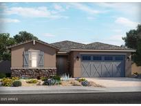 Charming single-story home featuring a two-car garage, stone accents, and desert landscaping at 24586 W Grenadine Rd, Buckeye, AZ 85326