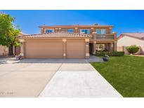 Inviting two-story home featuring a spacious three-car garage and charming balcony, perfect for outdoor relaxation at 2535 E Saratoga St, Gilbert, AZ 85296