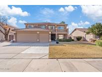 Two-story home with tile roof, balcony, three-car garage and manicured lawn on a sunny day at 2535 E Saratoga St, Gilbert, AZ 85296