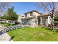 Charming two-story home featuring a well-maintained lawn and attached two-car garage at 3708 E Bruce Ave, Gilbert, AZ 85234