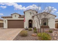 Charming single-story home with desert landscaping and a welcoming front entrance, and two car garage at 4887 N 184Th Ln, Goodyear, AZ 85395