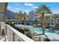 Resort style swimming pool with palm trees and view of mountains from balcony at 5455 E Lincoln Dr # 2009, Paradise Valley, AZ 85253