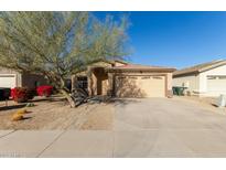 Charming single-Gathering home with a two-car garage, desert landscaping, and mature tree at 6042 W Warner St, Phoenix, AZ 85043