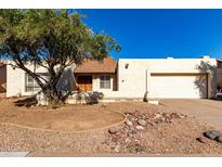 Charming single-story home featuring a low maintenance yard and a welcoming double-door entrance at 614 W Mcnair St, Chandler, AZ 85225