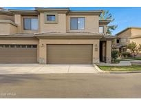 A townhome with a neutral color palette and a large garage, perfect for storage or parking at 705 W Queen Creek Rd # 2006, Chandler, AZ 85248