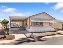 Charming single-story home featuring a covered porch and a well-maintained yard with desert landscaping at 7807 E Main St # Cc-84, Mesa, AZ 85207