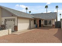 Charming single-story home with a well-maintained yard and attached garage at 9853 E Birchwood Ave, Mesa, AZ 85208