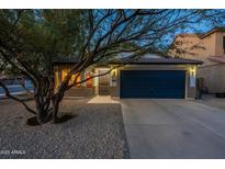 Charming single-story home featuring a desert landscape, a two-car garage, and a well-maintained front yard at 10594 E Wallflower Ln, Florence, AZ 85132