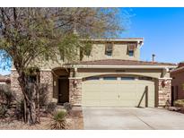 Charming two-story home featuring a two-car garage and stone accents at 12132 W Ashby Dr, Peoria, AZ 85383