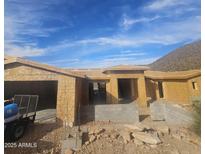 Exterior view of a home under construction featuring wood framing and a blue sky backdrop at 12946 N 116 St # 24, Scottsdale, AZ 85259