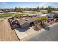 Charming home featuring desert landscaping and a spacious driveway with a convenient two-car garage at 14493 S Country Club Dr, Arizona City, AZ 85123