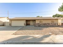 Charming single-story home featuring a two-car garage and low-maintenance landscaping at 1549 W Peralta Ave, Mesa, AZ 85202