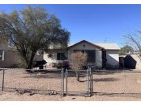 Charming single-story home with a chain-link fenced yard and mature tree at 1634 S 5Th St, Phoenix, AZ 85004