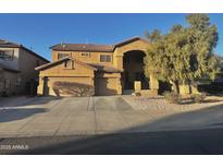 Inviting two-story home showcasing neutral stucco, a tile roof, and a spacious three-car garage at 17420 W Mohave St, Goodyear, AZ 85338