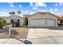 Charming home featuring a well-maintained yard and a spacious three-car garage at 17813 W Primrose Ln, Surprise, AZ 85374