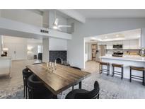 Open-concept dining area flows into the kitchen with white cabinets and stainless steel appliances at 19236 N 22Nd Ln, Phoenix, AZ 85027