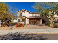 Charming two-story home with desert landscaping and a two-car garage, perfect for Gathering living at 2406 W Tallgrass Trl, Phoenix, AZ 85085