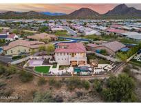 Expansive aerial view of a home with a basketball court, turf lawn, pool, pergola, and mountain views at 28826 N 67Th Dr, Peoria, AZ 85383