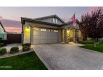 Charming exterior with stone accents, three-car garage, and well-manicured lawn at 3519 E Appaloosa Rd, Gilbert, AZ 85296