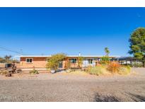 Charming single story home with desert landscaping and a gravel driveway under a clear blue sky at 417 W Sunset Dr, Mammoth, AZ 85618