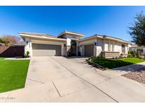 Beautiful home featuring a three-car garage, manicured lawn, and modern architectural design at 4675 S Bandit Rd, Gilbert, AZ 85297