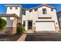 Charming two-story home featuring an attached two-car garage and manicured landscaping at 5460 S Dillon Cir, Mesa, AZ 85212