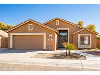 Charming single-story home featuring a well-maintained lawn, a two-car garage, and a welcoming entryway at 723 W Canary Way, Chandler, AZ 85286