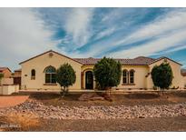 Charming single-story home with desert landscaping and a tile roof under a partly cloudy sky at 9405 S 47Th Ave, Laveen, AZ 85339