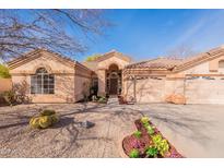 Charming single-story home featuring desert landscaping, a barrel tile roof, and a two-car garage at 1310 S Vine Ct, Gilbert, AZ 85233