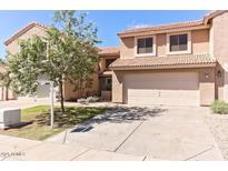 Inviting two-story home featuring a well-maintained front yard and a spacious two-car garage at 13820 S 41St Way, Phoenix, AZ 85044