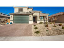 Beautiful two-story home with a well-manicured front yard and a two-car garage at 24578 W Concorda Dr, Buckeye, AZ 85326